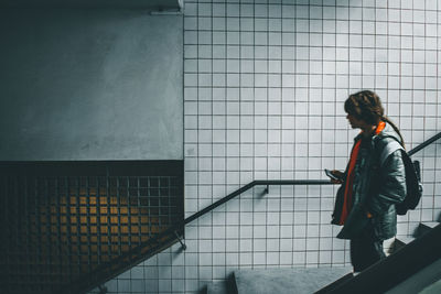 Rear view of man walking in subway