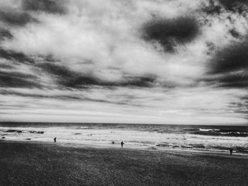 Scenic view of sea against cloudy sky