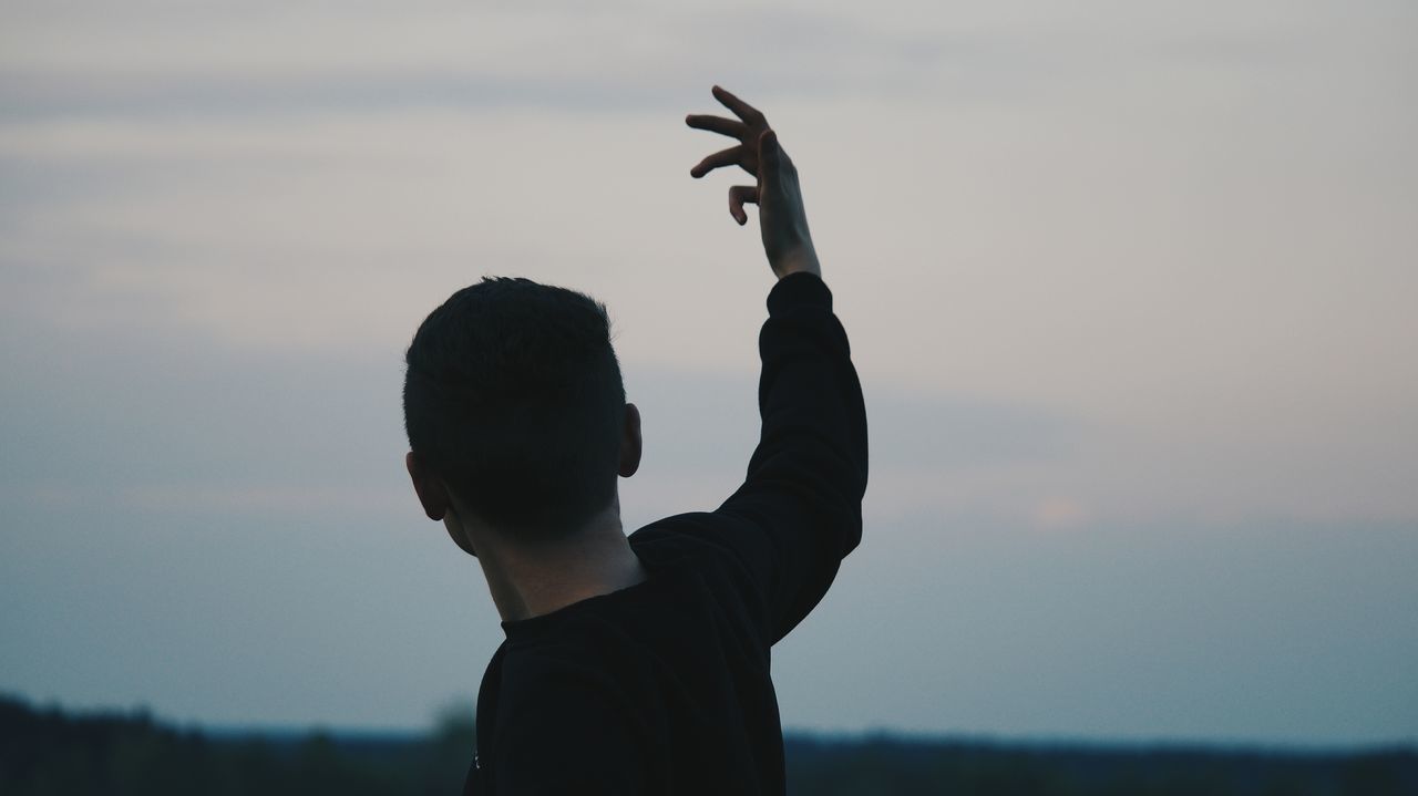 real people, one person, gesturing, sky, leisure activity, outdoors, lifestyles, focus on foreground, sunset, nature, silhouette, women, day, childhood, beauty in nature, human hand, people