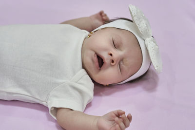 Portrait of cute baby boy sleeping on bed