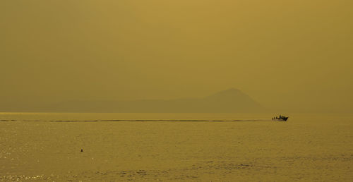 Scenic view of sea against clear sky during sunset