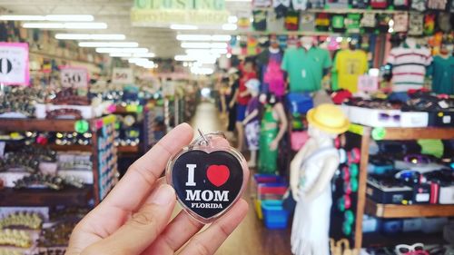 Midsection of woman holding display at store