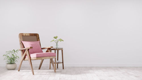 Empty chairs and table against wall at home