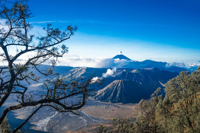 Scenic view of snowcapped mountains against blue sky