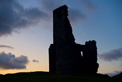 Low angle view of old ruin against sky during sunset