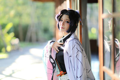 Portrait of young woman standing outdoors