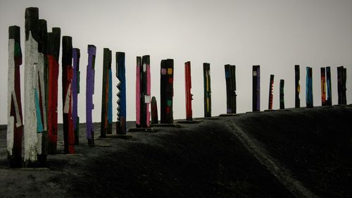 Row of multi colored pencils against sky