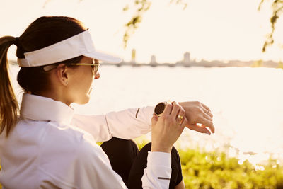 A woman checks her fitness smart watch.