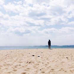 Rear view of woman standing on beach