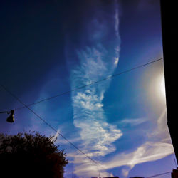 Low angle view of power cables against blue sky