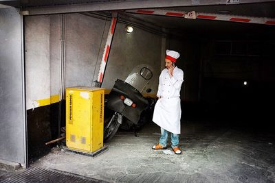 Full length of woman standing by railing