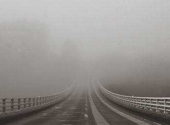 Panoramic view of foggy weather against sky during winter