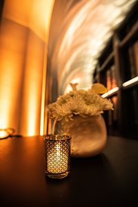 Close-up of illuminated lamp on table