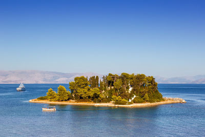 Scenic view of sea against clear blue sky