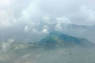 Scenic view of landscape against cloudy sky