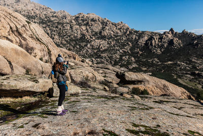 Full length of woman on rock against sky