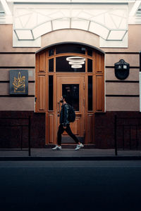 Full length side view of a man walking in corridor