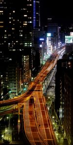 High angle view of illuminated city street and buildings at night