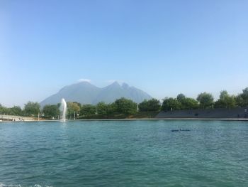 Scenic view of lake against clear blue sky