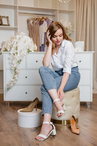 Beautiful girl trying on shoes in dressing room