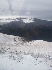 Scenic view of mountains against sky during winter