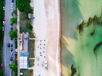 High angle view of swimming pool by sea against buildings