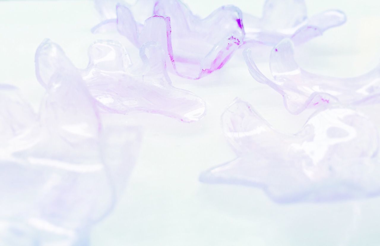 glass - material, purple, selective focus, full frame, nature, extreme close-up, purity, beauty in nature, white background, studio shot, dreamlike, ethereal, fragility