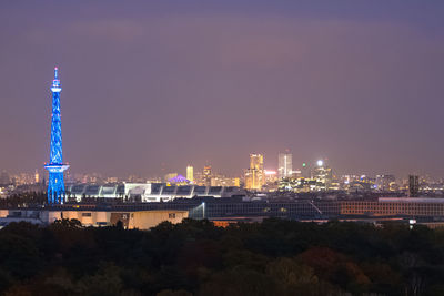 Illuminated cityscape against sky at night