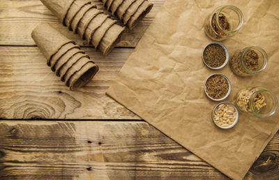 Top view of peat pots and glass jars with seeds on a wooden background. growing seedling .