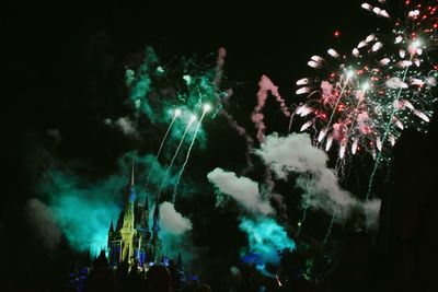 Panoramic view of firework display at night