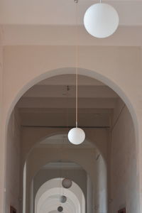 Low angle view of pendant light hanging in corridor