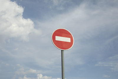 Low angle view of road sign against sky