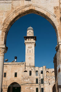 Low angle view of historical building against clear blue sky