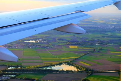 Aerial view of airplane flying over agricultural field