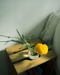 Close-up of yellow flower vase on table