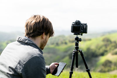 Man photographing with mobile phone