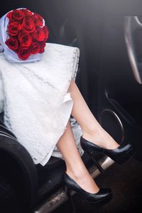 Low section of bride exiting car during wedding ceremony