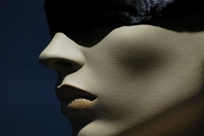 Close-up of human face against black background