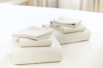 Close-up of white objects on bed