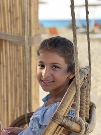 Close-up of young girl on a swing at the beach