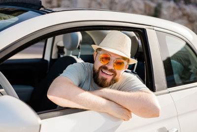 Portrait of young woman in car