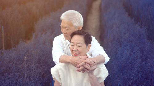 Man and woman standing against wall