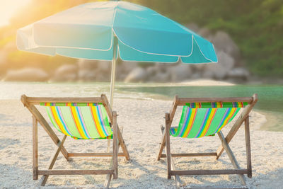 Empty chairs and tables on beach