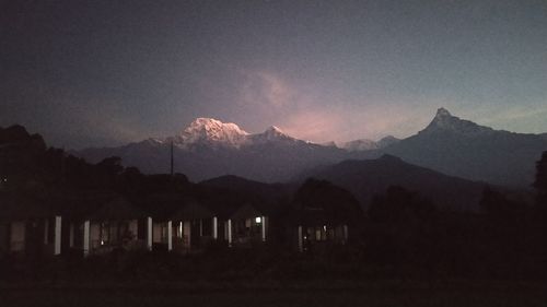 Scenic view of silhouette mountains against sky at sunset