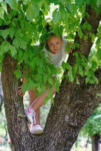 Portrait of girl with tree trunk