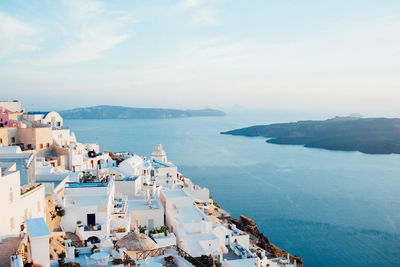 High angle view of townscape by sea against sky