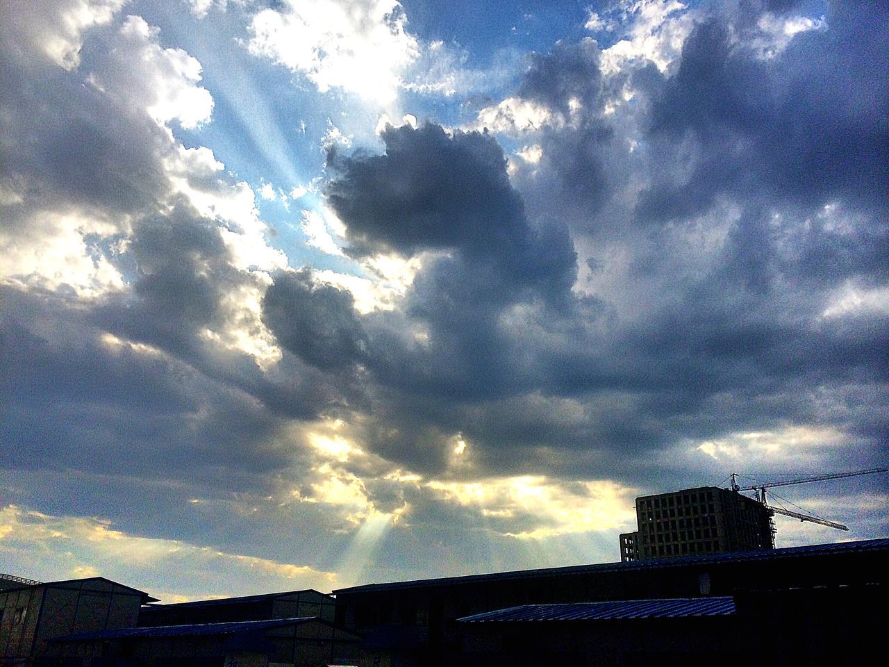 building exterior, sky, architecture, cloud - sky, built structure, cloudy, silhouette, city, low angle view, cloud, weather, sunset, building, overcast, nature, dusk, storm cloud, residential building, outdoors, sunlight