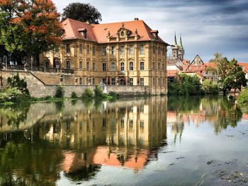 Reflection of trees and buildings in lake