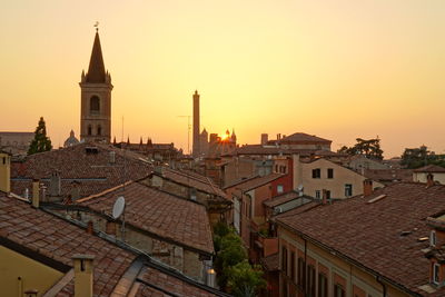 Buildings against sky during sunset in city