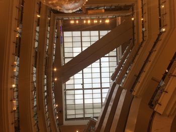 Low angle view of illuminated lights hanging on ceiling in building